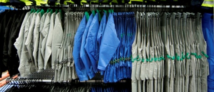 workwear hanging on wall display rails
