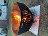 Outdoor fire pit bowl on stable metal stand 